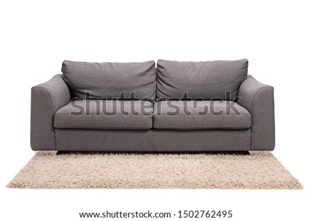 Studio shot of a grey sofa on a carpet isolated on white background Royalty-Free Stock Photo #1502762495