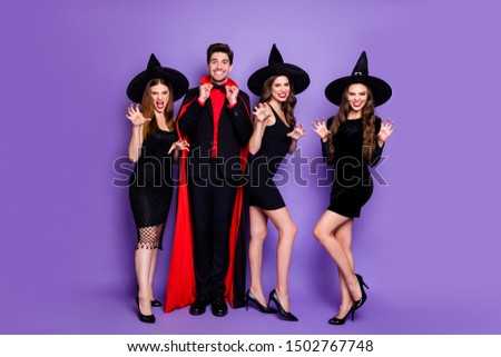 Full body photo of four group people wizard guy and witch girlfriends playing evil roles biting scratching wear dresses caps and cloak isolated purple color background