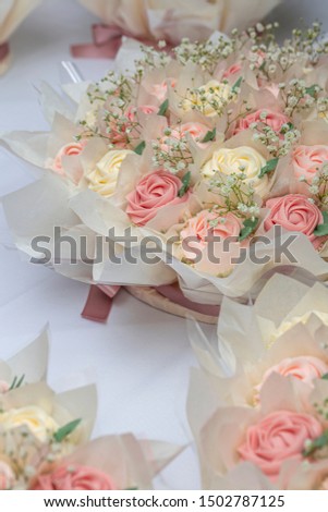 Beautifully decorated wedding rose cupcakes in pastel tones on the top of table