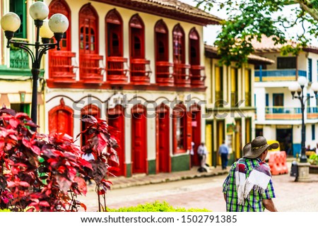 View on colorful red colonial buildings at central square of village Jerico in Colombia Royalty-Free Stock Photo #1502791385