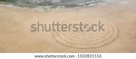 A circular rock labyrinth is found on the edge of the Pacific Ocean just north of San Francisco, California. Labyrinths symbolize the journey through life from birth to spiritual awakening to death.