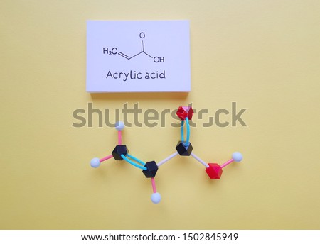 Molecular structure model and structural chemical formula of acrylic acid molecule. It is an unsaturated carboxylic acid, used in many industries like the diaper industry, the textiles industry, etc.