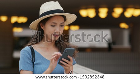 Woman use of smart phone in city