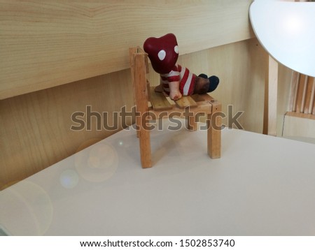 girl sit alone facing the light on the wooden chair