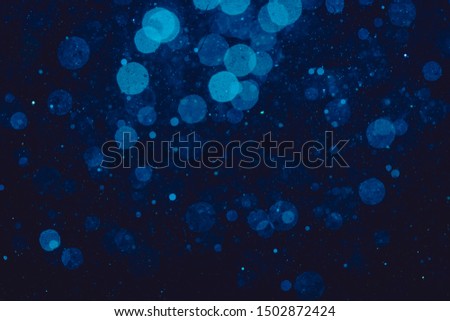 blue bokeh of lights on black background