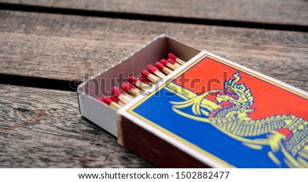 Box of matches isolated  on wooden background.                                          