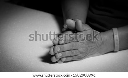 Women holding hands and praying black and white pictures
