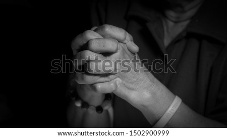 Women holding hands and praying black and white pictures