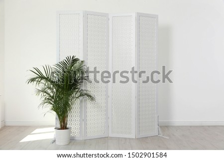 Modern folding screen in light spacious room