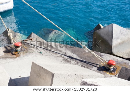 Tenerife, Canary Islands, Spain - : Pier with cement concrete pavements in the harbor of Los Cristianos.