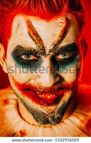 A close up portrait of a smiling clown from a horror film. Halloween, carnival.