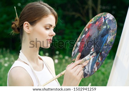 woman paints a paint style picture