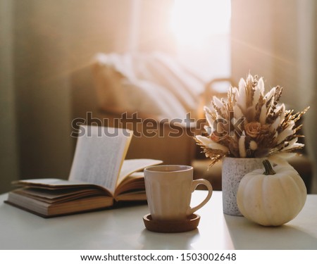 Autumn still life. Coffee cup, flowers, book and pumpkin. Hygge lifestyle, cozy autumn mood. Flat lay, Happy thanksgiving background
 Royalty-Free Stock Photo #1503002648
