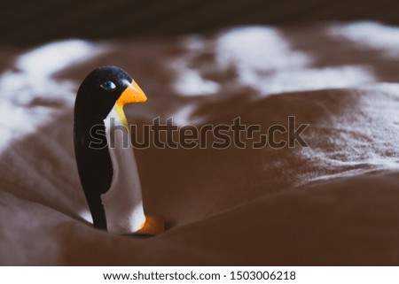 Small sculpture of acute  penguin