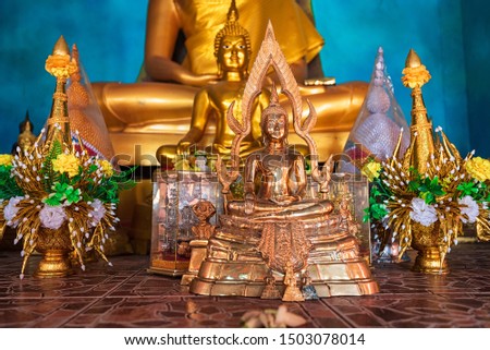 Yellow gold Buddha at wat tum sua temple Amphur Tamuang, Kanchanaburi, Thailand.Most popular temple.