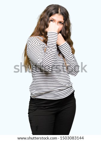 Young beautiful woman wearing stripes sweater Ready to fight with fist defense gesture, angry and upset face, afraid of problem