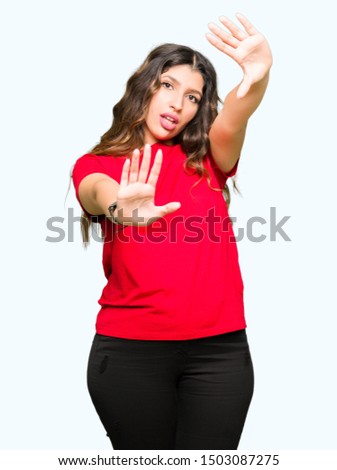 Young beautiful woman wearing casual t-shirt Smiling doing frame using hands palms and fingers, camera perspective