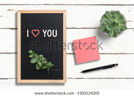 message "I love you" on a letter board on wooden background