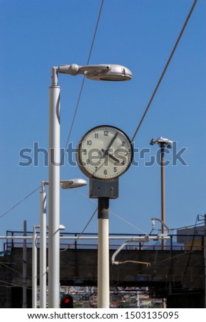 Empty railway station platform with old watch. Travel and tourism concept.