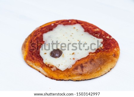 Sicilian Pizzetta. A typical street food from Sicily. Made with olive, tomato, and cheese.