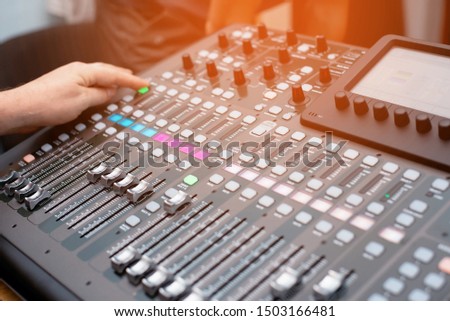 the mixer. remote for sound recording. sound engineer at work in the studio. sound amplifier mixing console equalizer. record songs and vocals. mixing tracks. audio equipment. work with musicians. DJ
