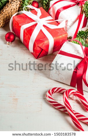 Christmas festive background with christmas tree branches and xmas gift boxes, top view copy space