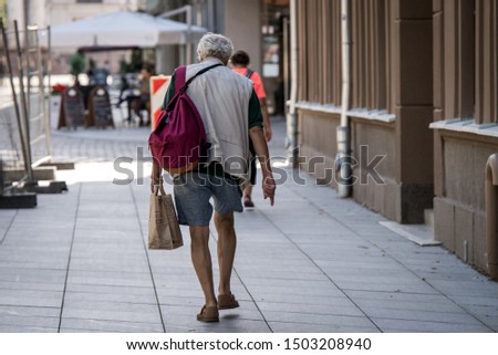 old man walking in the city