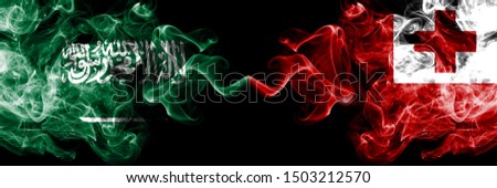 Saudi Arabia Kingdom vs Tonga, Tongan smoky mystic flags placed side by side. Thick colored silky smoke flags of Arabic, Arabian and Tonga, Tongan