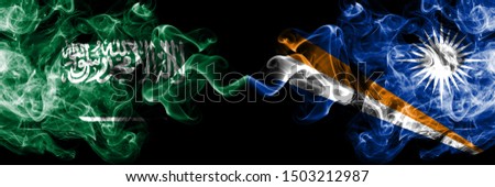 Saudi Arabia Kingdom vs Marshall Islands smoky mystic flags placed side by side. Thick colored silky smoke flags of Arabic, Arabian and Marshall Islands