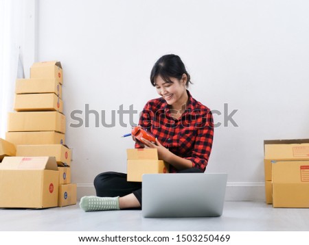 Asian woman working with laptop for selling online, deliverly concept.