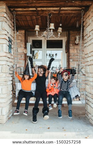 Children in Halloween costumes, having fun   