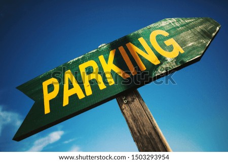Vividly painted parking arrow made of wood. 