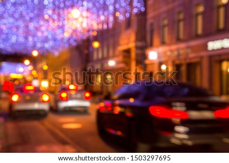Traffic in the night city. Night illumination on the street. The focus is blurred
