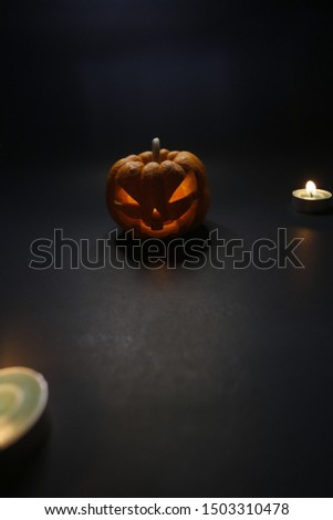 Halloween pumpkin lantern on a dark background.