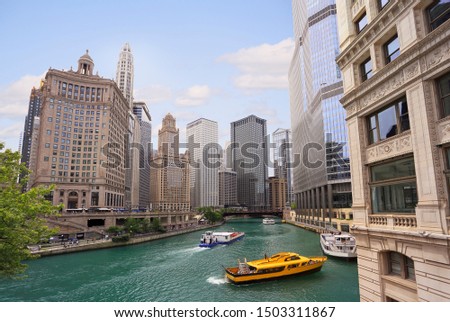 Chicago River with water taxi and boats sailing between the beautiful skyscrapers skyline, Illinois, USA