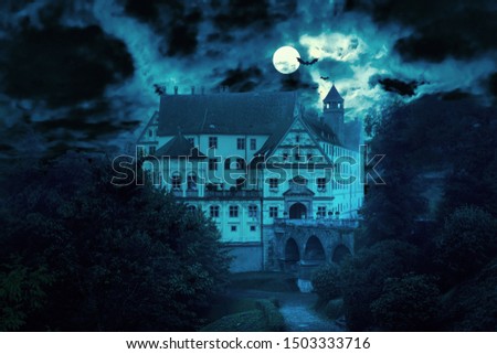 Haunted house at night. Old spooky castle in full moon. Creepy view of dark mystery mansion with bats. Scary gloomy scene for Halloween theme. Horror and terror concept.