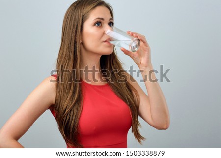 Woman drinking water. Female Isolated portrait with water glass.