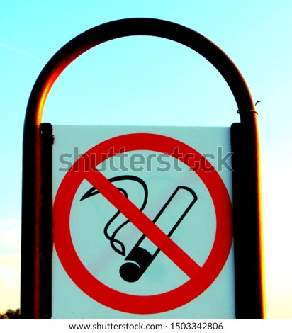 A sign prohibiting smoking in a public place in the form of a crossed cigarette crossed out with a red line