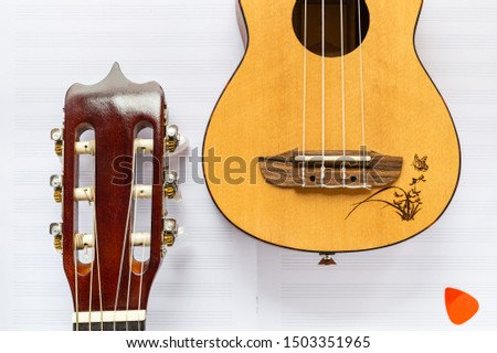 Guitar and ukulele. Wooden, plucked instruments. Nylon strings. Musical instruments. Learning and having fun. Musical groups. Singing and music.