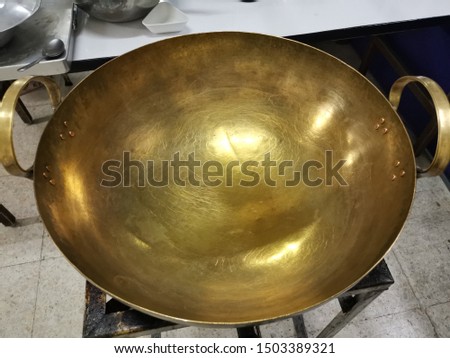 Brass pan is a cookware used to fry foods to heat up the food quickly cooked Royalty-Free Stock Photo #1503389321