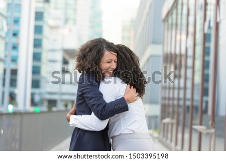 Old female friends glad to see each other outside. Business women standing in city street and hugging. Meeting and joy concept Royalty-Free Stock Photo #1503395198