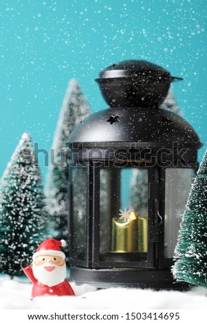 Christmas background with Santa claus, Lantern and christmas trees on table.
