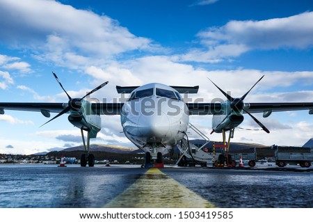 Turboprop passenger airplane captured from font uprisen angle parking at the airport Royalty-Free Stock Photo #1503419585