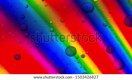 Water drops cover rainbow LCD screen, macro shot