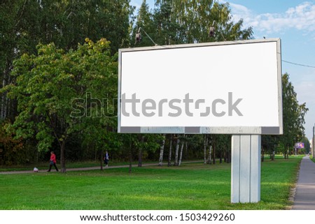 blank billboard, a large billboard on the background of the park and the street. UPS mock up isolated on white.