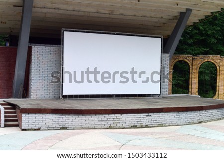 Russia. Nizhny Novgorod Region. Sarov. Photo of a background with a stage with a brick fence and a white screen for projection.

