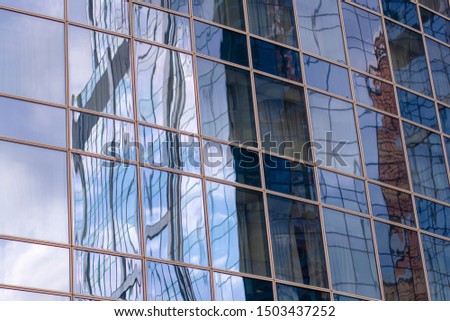 Close-up Windows on a glass office building with a Sunny reflection of the sunset.
