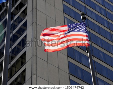 American flag on the background of a modern building.