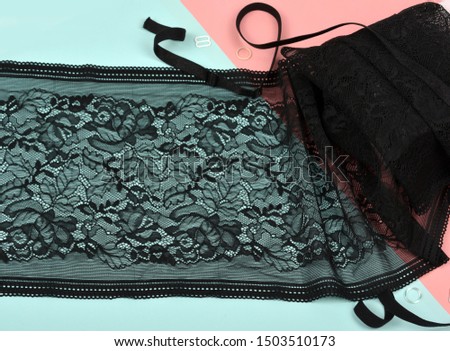 Delicate black laces for panties and bras on color background