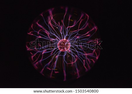 Electromagnetic Fields in a glass globe, purple, red and white lightnings. Royalty-Free Stock Photo #1503540800